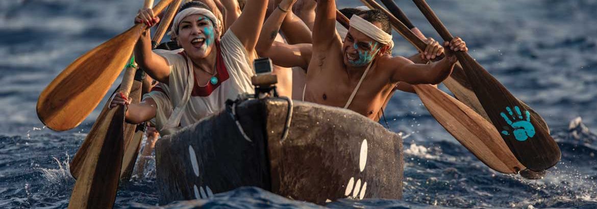 oarsmen and women crossing the deep blue water between Xcaret and Cozumel