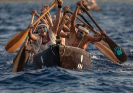 oarsmen and women crossing the deep blue water between Xcaret and Cozumel